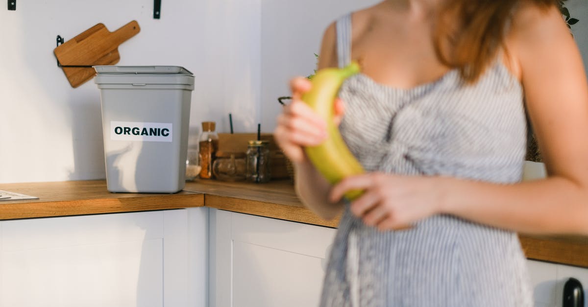 Where can I eat a guinea pig in Ecuador? - Crop woman with organic banana in hands standing in kitchen Where can I eat a guinea pig in Ecuador? - Crop woman with organic banana in hands standing in kitchen