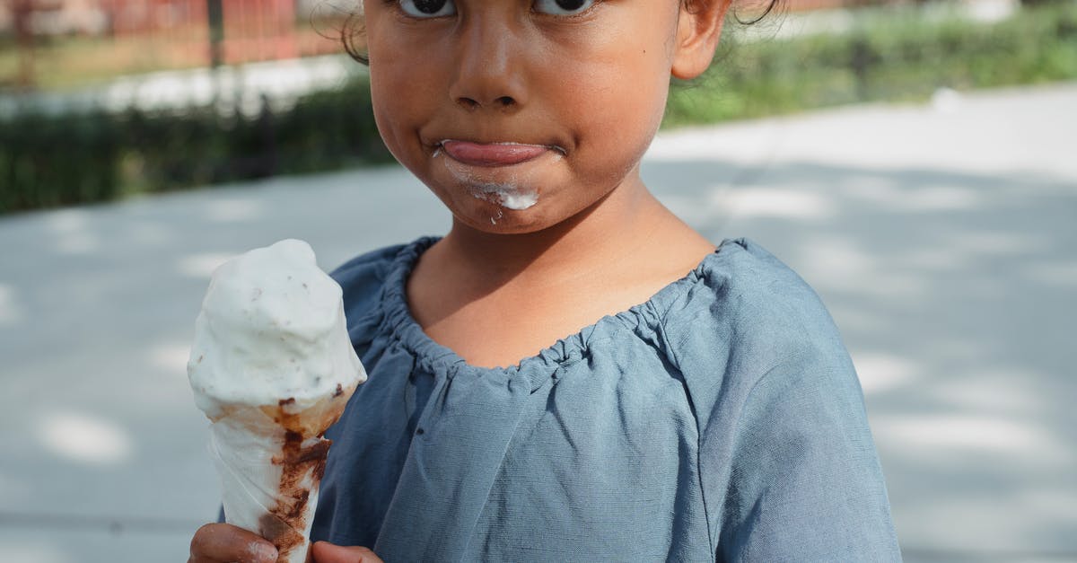 Where can I eat out in Turkey without rudeness about my ethnicity or nationality? [closed] - Crop adorable little Asian girl in casual clothes eating ice cream and looking at camera