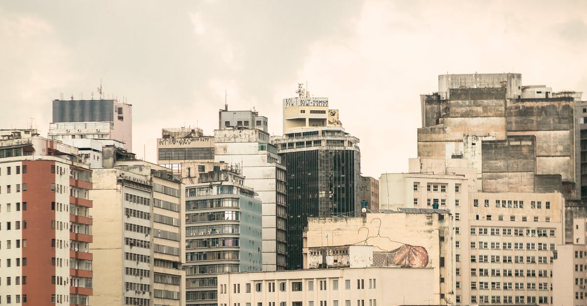 Where can I find a house or apartment or any other residence in Chiclayo(Perú)? [closed] - Multistory residential apartment houses with shabby walls located close to each other on city street against gray sky in district