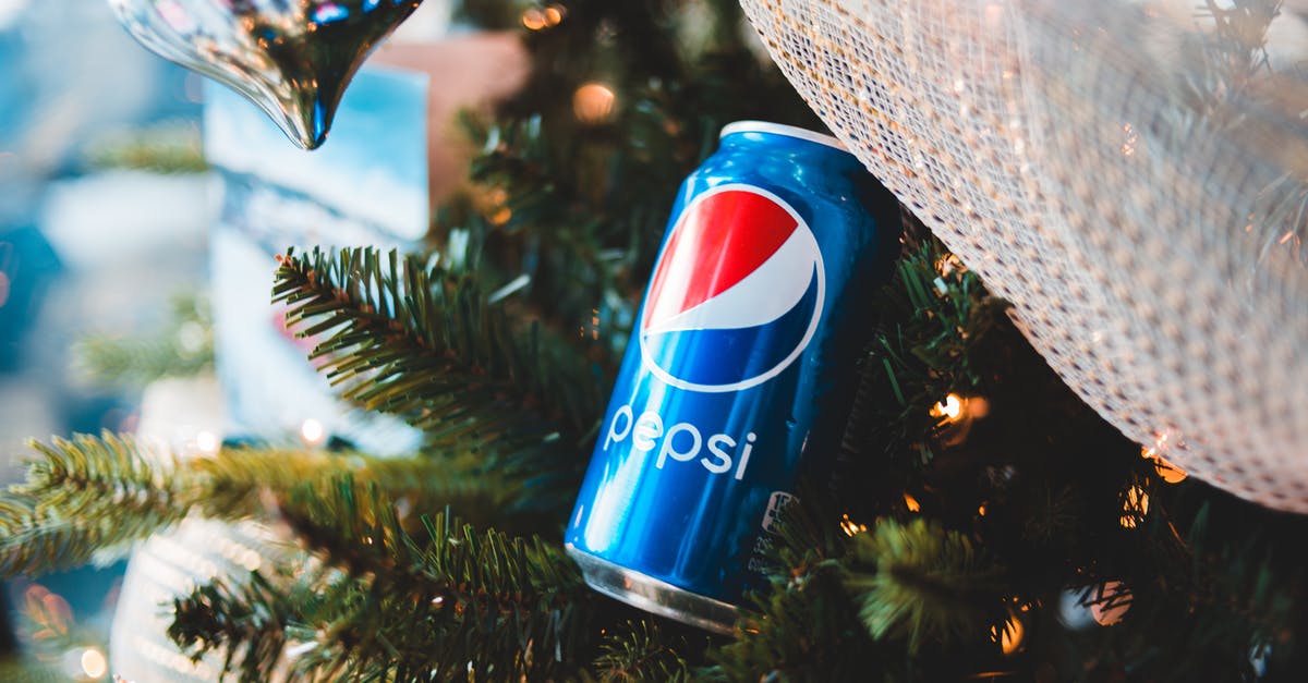Where can I find event listings for Mumbai? - Shiny can of soft drink on Christmas tree branch Where can I find event listings for Mumbai? - Shiny can of soft drink on Christmas tree branch