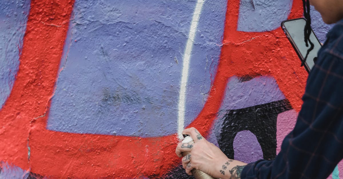 Where can I find Hostelworld's rankings for cities? - Side view of crop unrecognizable painter spraying paint on colorful wall with patterns while creating graffiti on street of city Where can I find Hostelworld's rankings for cities? - Side view of crop unrecognizable painter spraying paint on colorful wall with patterns while creating graffiti on street of city