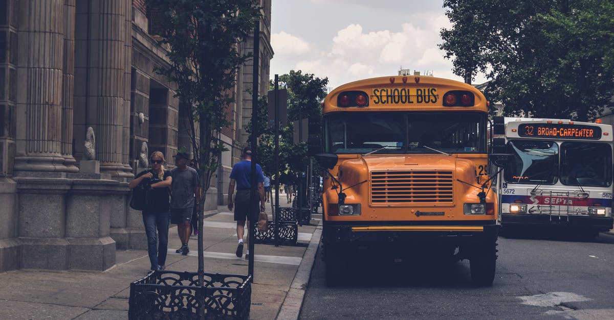 Where can I find maps of buses / bus routes in Muscat? - Yellow School Bus Beside Gray Concrete Building Where can I find maps of buses / bus routes in Muscat? - Yellow School Bus Beside Gray Concrete Building