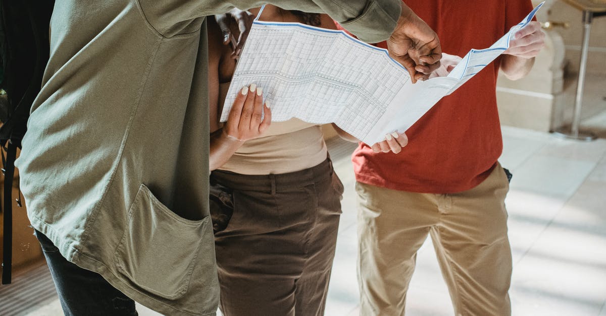 Where can I find Taizé groups in Barcelona? - Anonymous diverse tourists exploring map during trip Where can I find Taizé groups in Barcelona? - Anonymous diverse tourists exploring map during trip