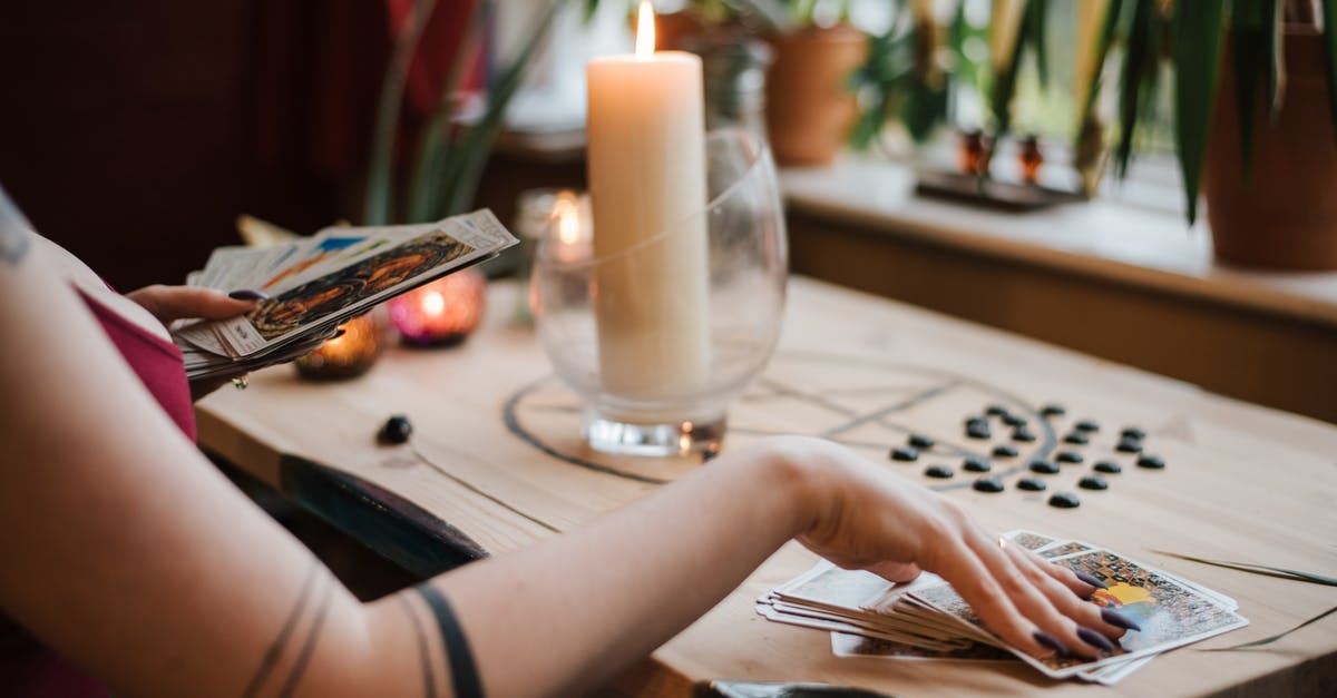 Where can I get an anonymous Rav Kav card issued? - Crop unrecognizable fortune teller predicting fate with tarot cards near shiny candle at home Where can I get an anonymous Rav Kav card issued? - Crop unrecognizable fortune teller predicting fate with tarot cards near shiny candle at home