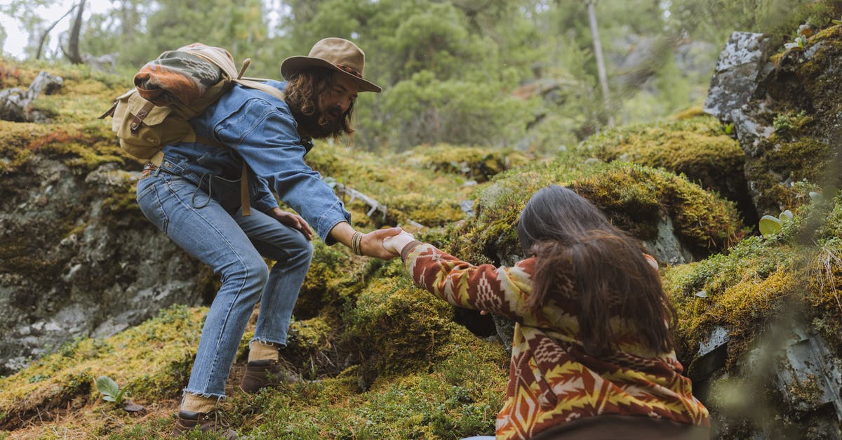 Where can I obtain Trek permits for Har-ki-doon? - Man and Woman Climbing a Mountainside Where can I obtain Trek permits for Har-ki-doon? - Man and Woman Climbing a Mountainside