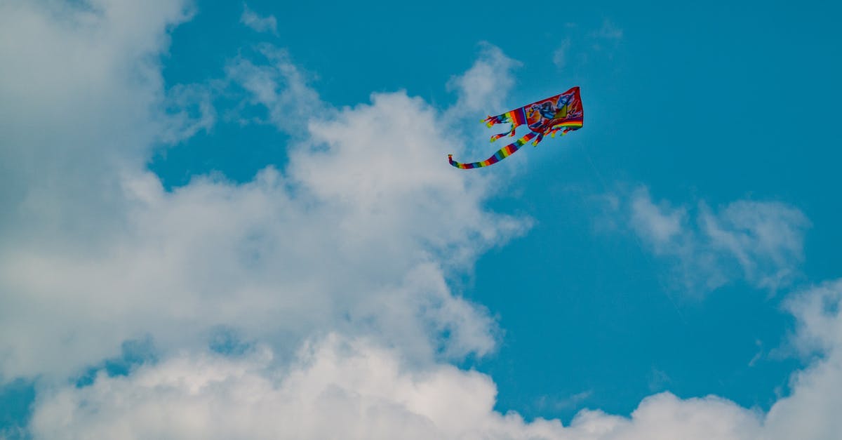 Where can I rent and fly a kite in Singapore? - From below scenery of multicolored bright kite soaring in peaceful blue sky Where can I rent and fly a kite in Singapore? - From below scenery of multicolored bright kite soaring in peaceful blue sky