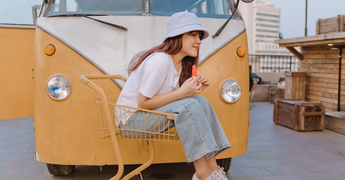Where can I ride a pump trolley? - Delighted Asian female with watermelon near retro van Where can I ride a pump trolley? - Delighted Asian female with watermelon near retro van