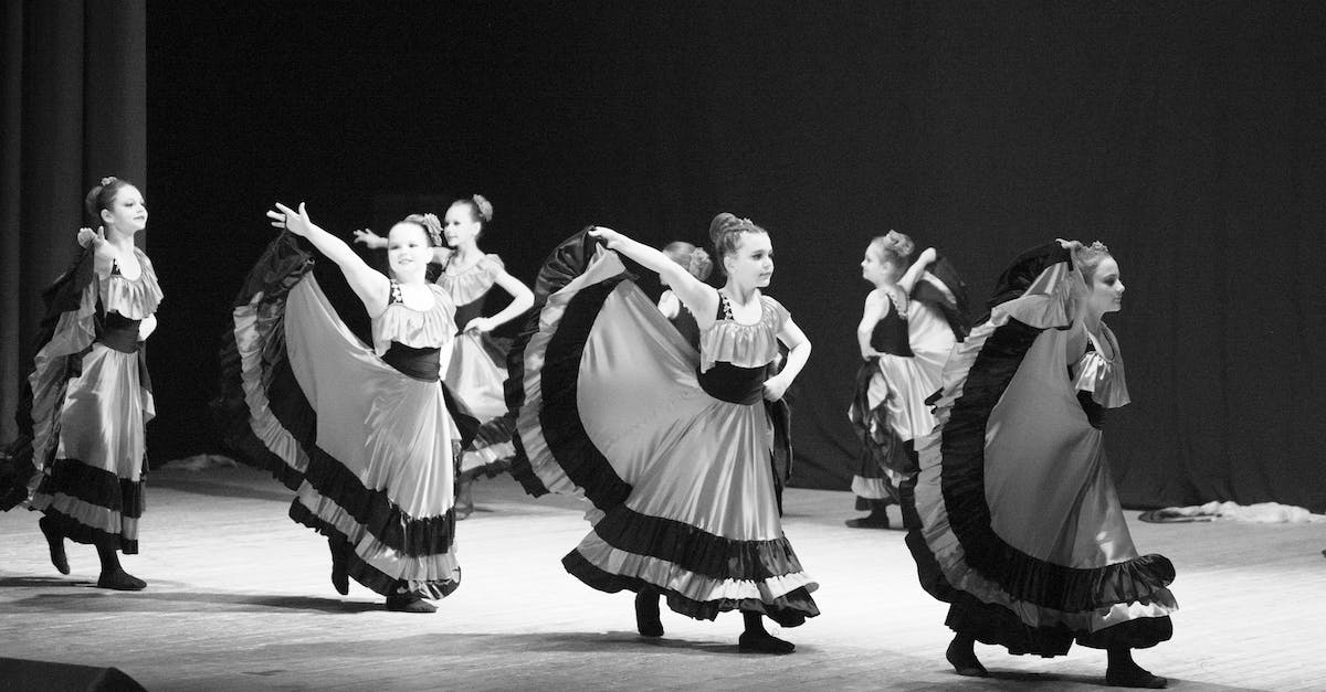 Where can I see a Mbalax performance in Dakar? - Grayscale Photo of Women Dancing Where can I see a Mbalax performance in Dakar? - Grayscale Photo of Women Dancing