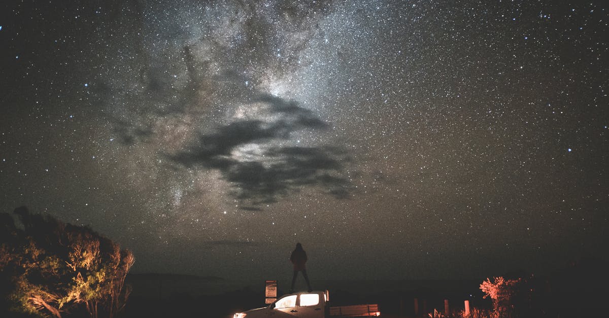 Where can I see the Milky Way in Europe? - Traveler standing on car at starry night Where can I see the Milky Way in Europe? - Traveler standing on car at starry night