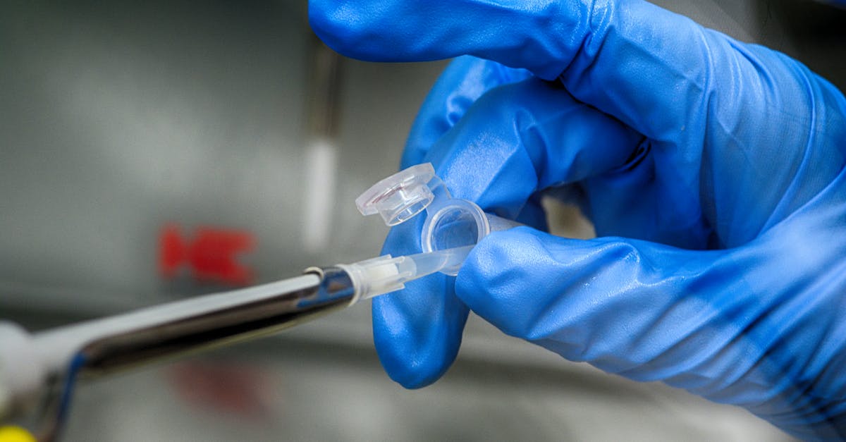 Where can I take a COVID-19 antigenic test in Paris? - Crop unrecognizable scientist in blue latex gloves taking sample from plastic tube in modern laboratory Where can I take a COVID-19 antigenic test in Paris? - Crop unrecognizable scientist in blue latex gloves taking sample from plastic tube in modern laboratory