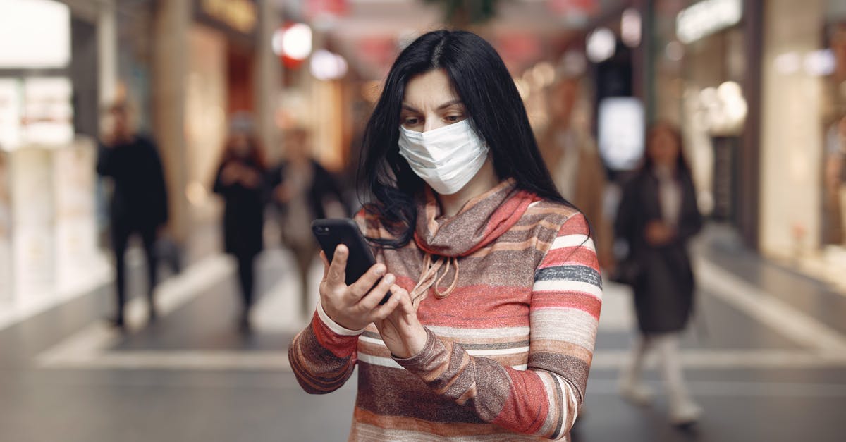 Where can I take a selfie with kangaroos in Australia? - Young female customer in striped wear and protection mask on face using smartphone while standing in shopping mall during coronavirus pandemic Where can I take a selfie with kangaroos in Australia? - Young female customer in striped wear and protection mask on face using smartphone while standing in shopping mall during coronavirus pandemic