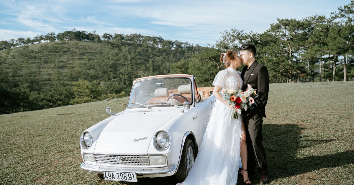 Where can one park one's car for free for a few weeks reasonably close to Seattle (SEA) airport? [closed] - Young Asian couple kissing near retro car in hillscape