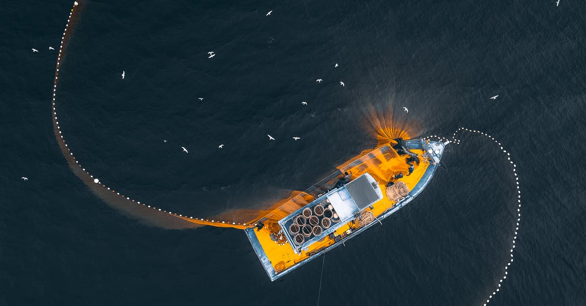 Where can one still sail on cruise ships without being vaccinated, with the least possible differences of treatment on board? - Aerial top view of modern fishing vessel with nets floating on dark seawater in daylight Where can one still sail on cruise ships without being vaccinated, with the least possible differences of treatment on board? - Aerial top view of modern fishing vessel with nets floating on dark seawater in daylight