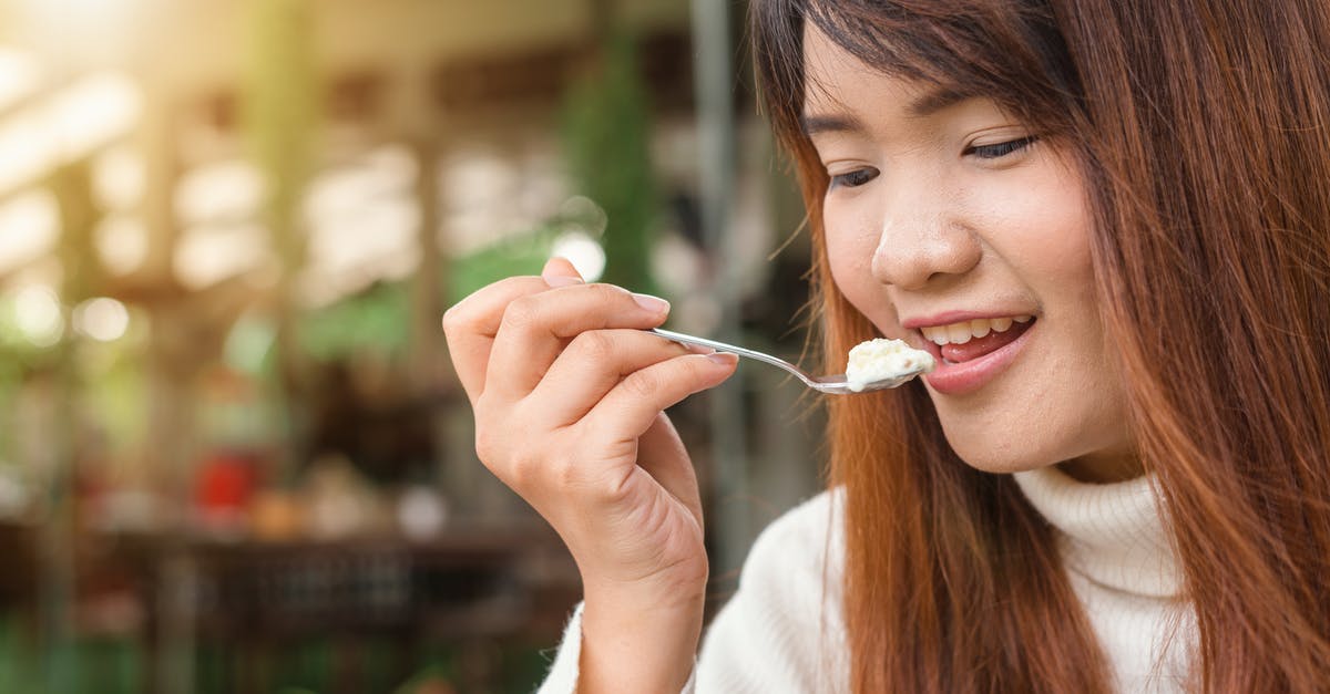 Where can people allergic to dairy eat when travelling in France? - Woman Holding Spoon Trying to Eat White Food Where can people allergic to dairy eat when travelling in France? - Woman Holding Spoon Trying to Eat White Food