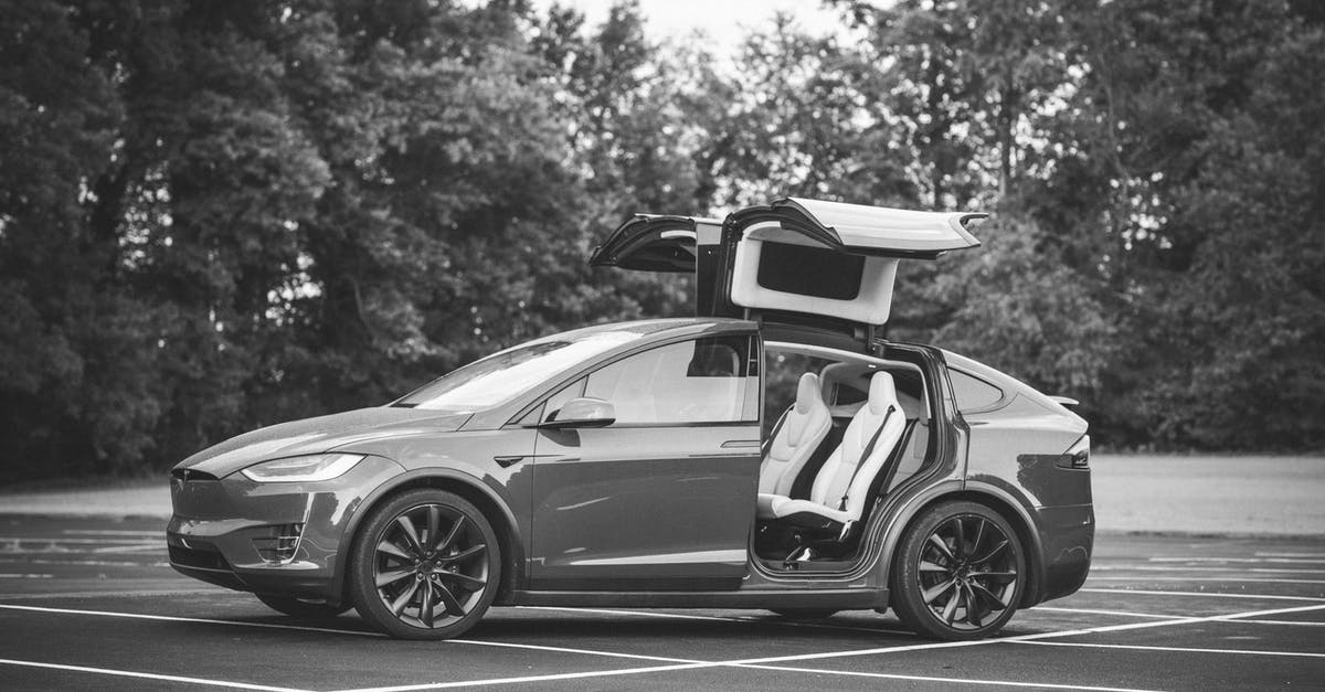 Where can you rent Tesla S or X model in Frankfurt? - Grayscale Photo of Sports Car on Road