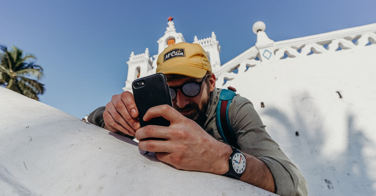 Where could I watch Mallakhamb in India - specifically in/around Delhi? - Man in Gray Jacket Holding Black Smartphone Where could I watch Mallakhamb in India - specifically in/around Delhi? - Man in Gray Jacket Holding Black Smartphone
