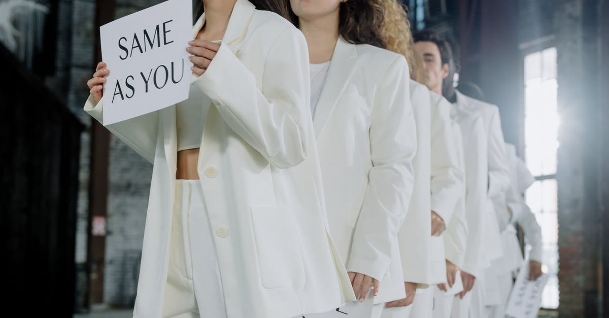 Where do you go once leaving the plane? Are there signs and so forth? - People in White Outfits Holding Placards Where do you go once leaving the plane? Are there signs and so forth? - People in White Outfits Holding Placards