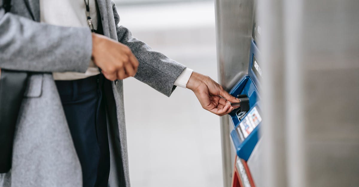 Where in LGA Terminal B can one buy a Metro Card? - Faceless woman buying metro ticket via electronic machine Where in LGA Terminal B can one buy a Metro Card? - Faceless woman buying metro ticket via electronic machine