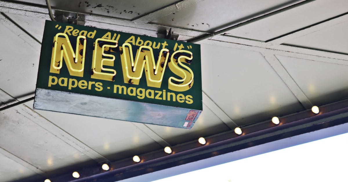 Where in Seattle can I withdraw Euros? - From below of illuminated signboard with news papers magazines inscriptions hanging on metal ceiling on street Where in Seattle can I withdraw Euros? - From below of illuminated signboard with news papers magazines inscriptions hanging on metal ceiling on street
