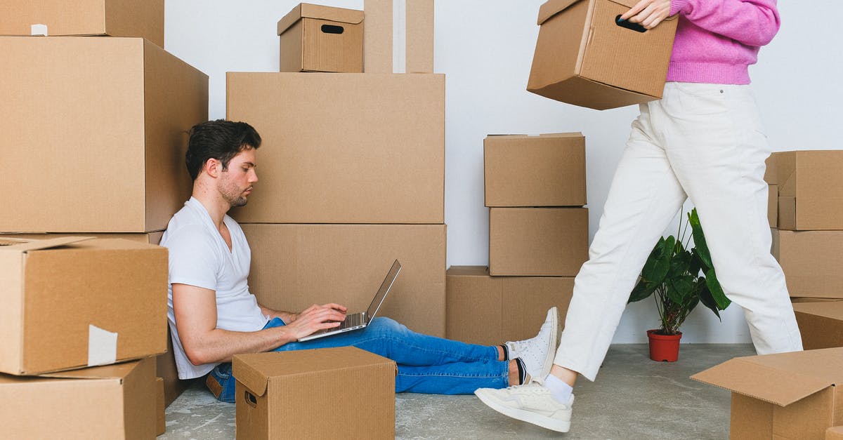Where in Seoul can I rent a laptop? - Crop woman arranging carton boxes during relocation with boyfriend using laptop on floor Where in Seoul can I rent a laptop? - Crop woman arranging carton boxes during relocation with boyfriend using laptop on floor