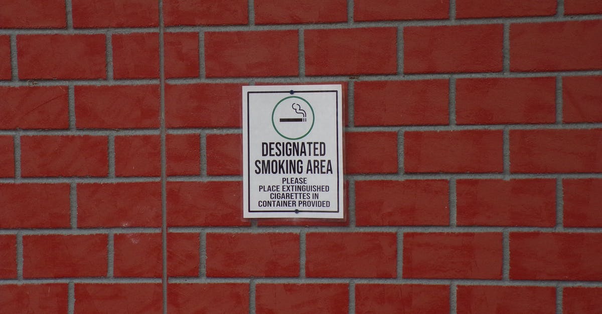 Where is smoking allowed in South Korea? - Building with brick wall and signboard with title indicating smoking area with symbol of cigarette Where is smoking allowed in South Korea? - Building with brick wall and signboard with title indicating smoking area with symbol of cigarette