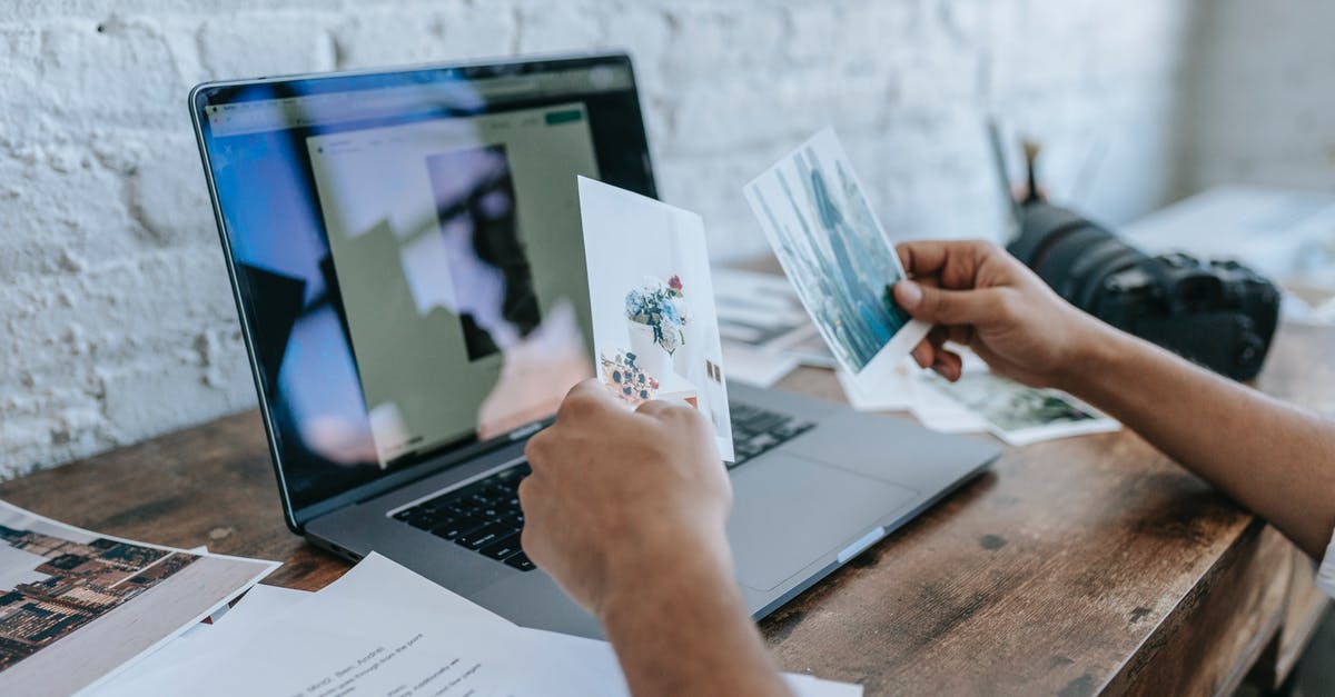 Where is the background photo used by Office 365 taken? - Crop unrecognizable man choosing photos and working on laptop Where is the background photo used by Office 365 taken? - Crop unrecognizable man choosing photos and working on laptop