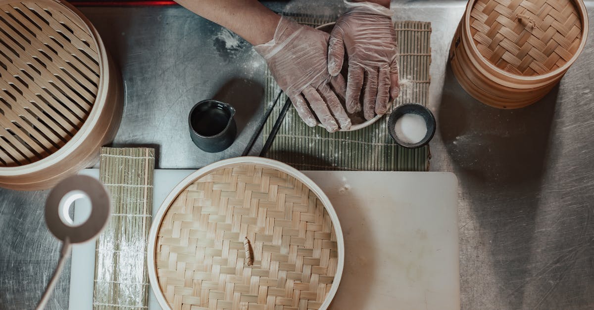 Where is the Bamboo restaurant located in Kyoto? - Person in Gloves Cooking on the Table Beside Bamboo Baskets Where is the Bamboo restaurant located in Kyoto? - Person in Gloves Cooking on the Table Beside Bamboo Baskets