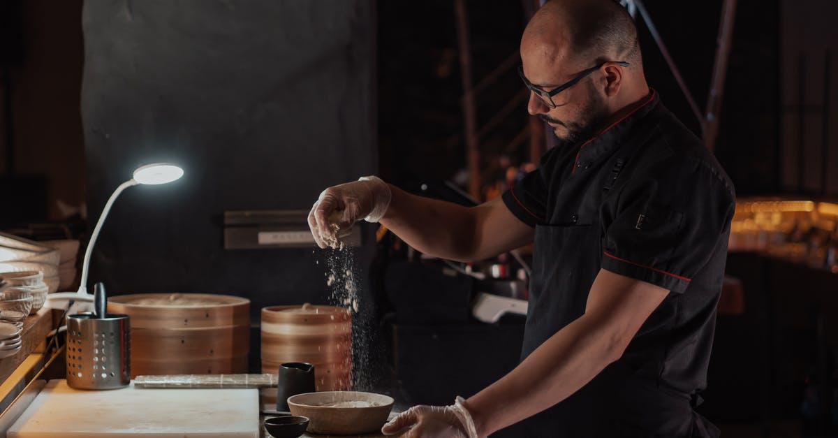 Where is the Bamboo restaurant located in Kyoto? - Man in Black Chef Uniform Sprinkling Flour on Ceramic Bowl Where is the Bamboo restaurant located in Kyoto? - Man in Black Chef Uniform Sprinkling Flour on Ceramic Bowl