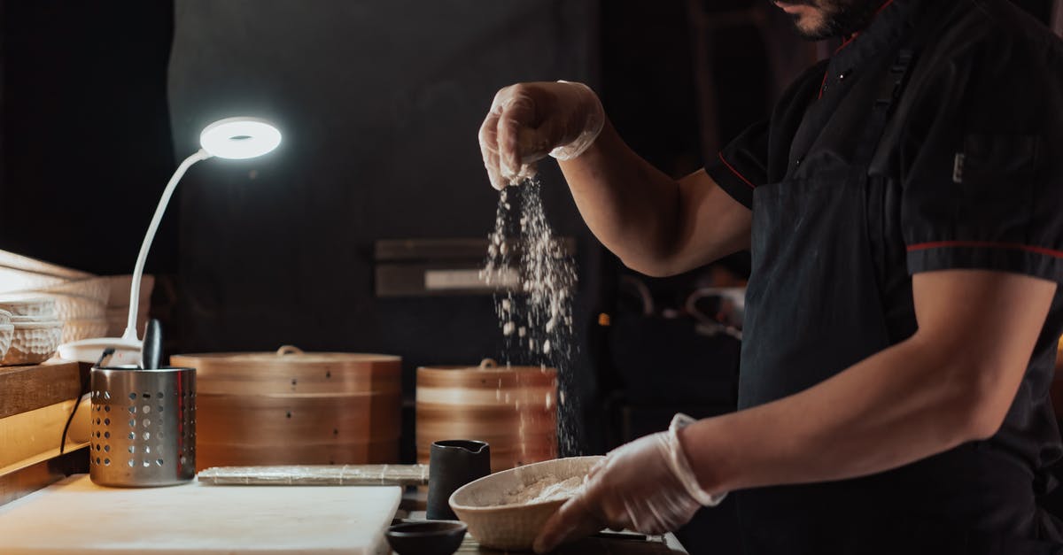 Where is the Bamboo restaurant located in Kyoto? - Man in Black Chef Shirt Sprinkling Flour Above Ceramic Bowl Where is the Bamboo restaurant located in Kyoto? - Man in Black Chef Shirt Sprinkling Flour Above Ceramic Bowl