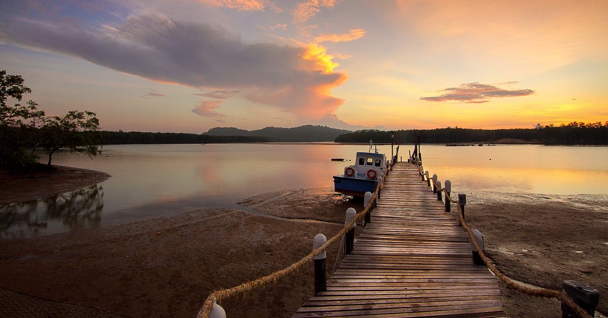Where is the jetty where you take the boat to visit the Embera communities? - White Boat Beside Wooden Dock Where is the jetty where you take the boat to visit the Embera communities? - White Boat Beside Wooden Dock