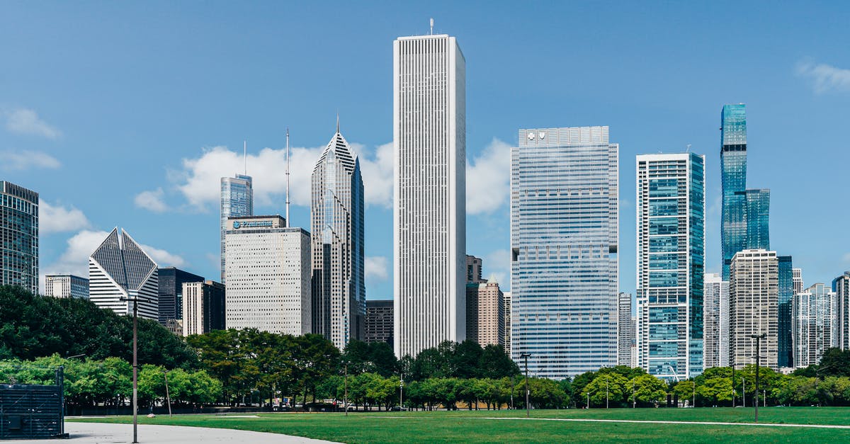 Where is the smallest park by area? - Modern city district with skyscrapers near green lawn Where is the smallest park by area? - Modern city district with skyscrapers near green lawn