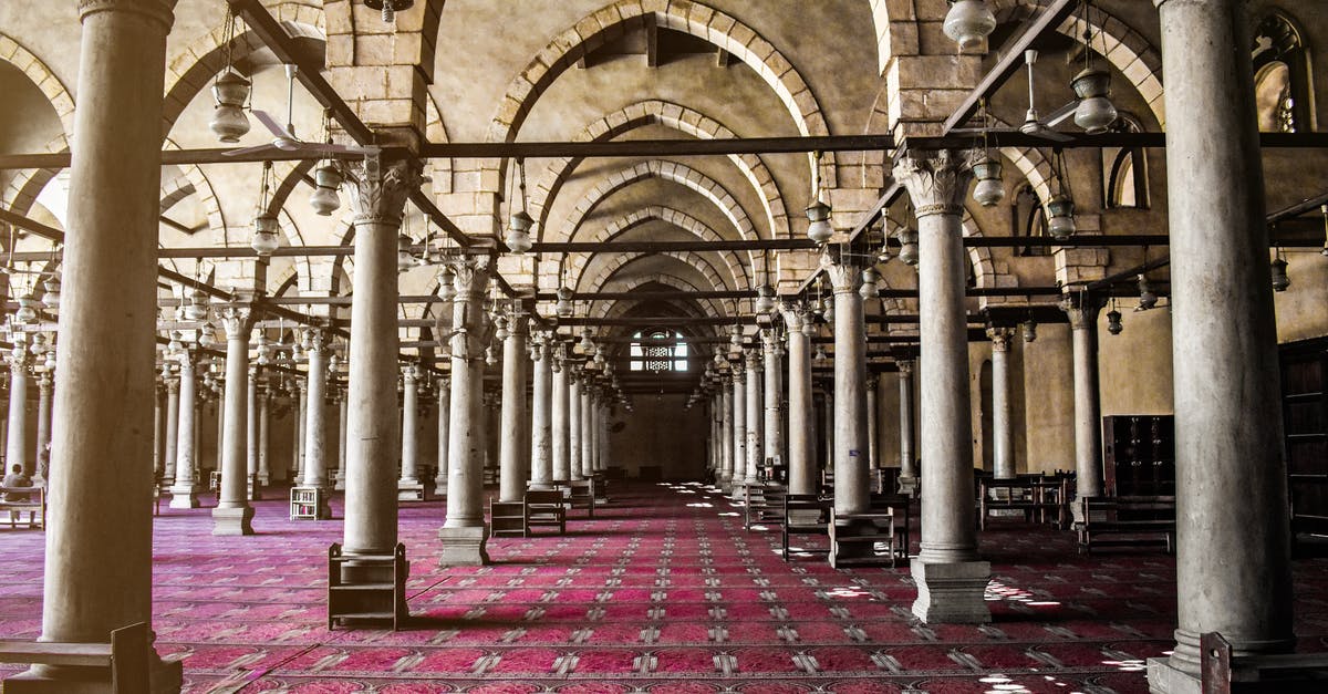 Where is this Indian-style palace with a large pool? - Interior design of large passage covered with ornamental red carpet and decorated with arches and columns Where is this Indian-style palace with a large pool? - Interior design of large passage covered with ornamental red carpet and decorated with arches and columns