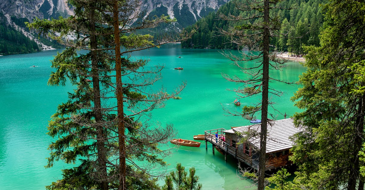 Where is this? (Likely Alpine lake.) - Brown Wooden Dock Near Brown Wooden Kayak in Water Where is this? (Likely Alpine lake.) - Brown Wooden Dock Near Brown Wooden Kayak in Water