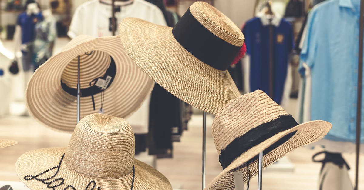 Where should I buy travel insurance if I'm living in the UK on a work visa? [closed] - Four Brown Straw Hats Display