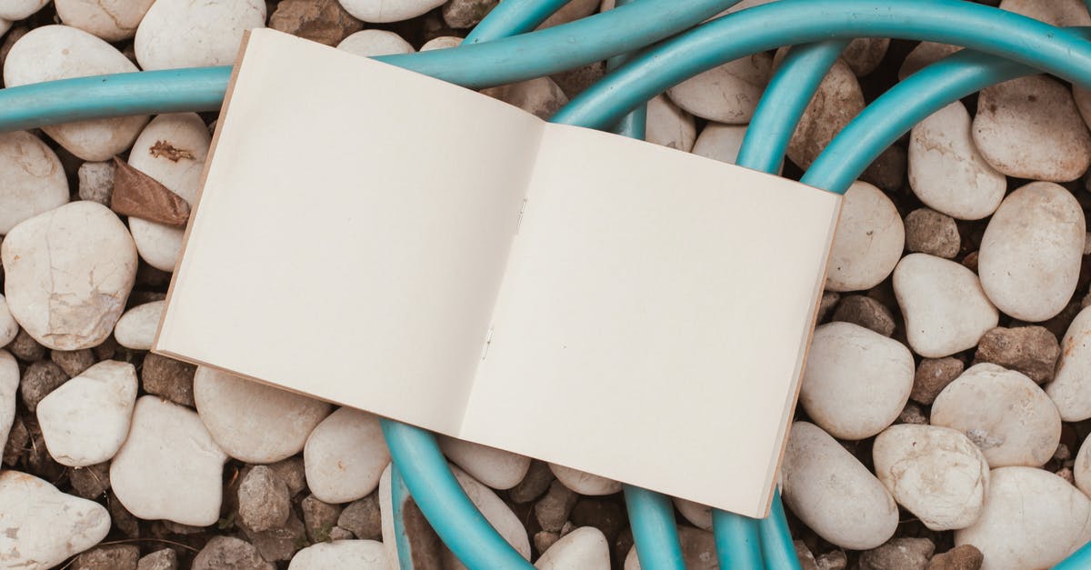 Where should I have two consecutive empty pages when applying for a Schengen visa? - A Blank Notebook on Top of Stones and Blue Wires