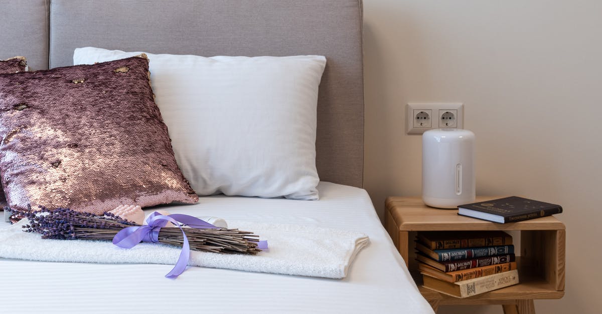 Where to book Henn-na Hotel Maihama - Lavender bouquet placed on bed in cozy bedroom in sunny morning Where to book Henn-na Hotel Maihama - Lavender bouquet placed on bed in cozy bedroom in sunny morning