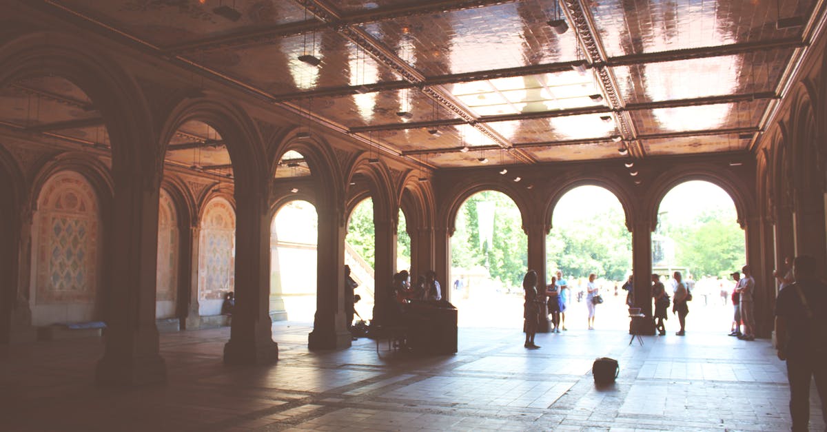 Where to find old buildings: taverns, castles, cathedrals, etc to visit while in London [closed] - Tourists standing near beautiful ornamental pavilion decorated with arches and mosaic during sunny summer day
