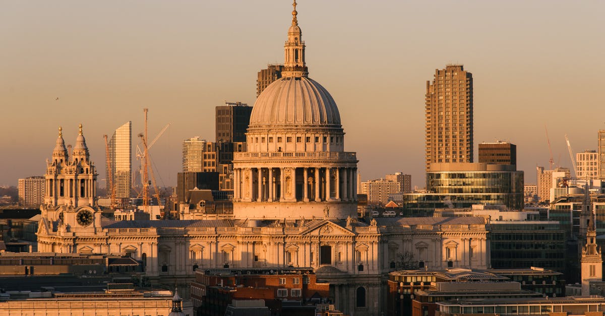 Where to find old buildings: taverns, castles, cathedrals, etc to visit while in London [closed] - Aged famous cathedral with dome framed by the spires of churches located near buildings against modern skyscrapers on streets of London