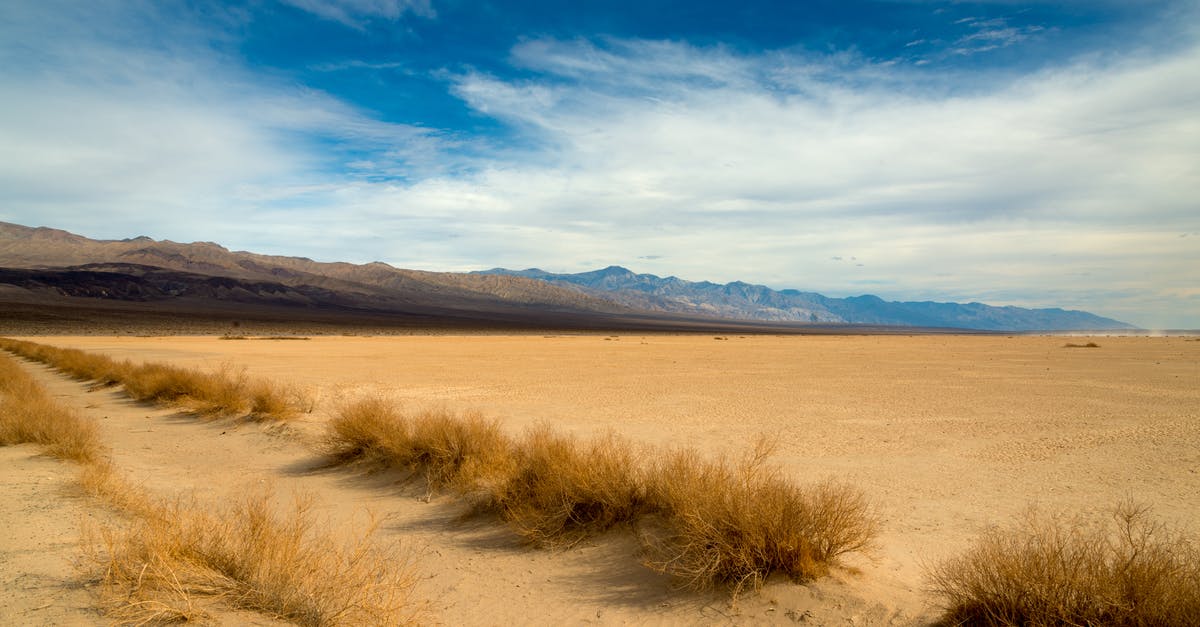 Where to go in India in June and avoid the hot climate as well as the monsoon? [closed] - Sandy Desert with Mountain Range in Background