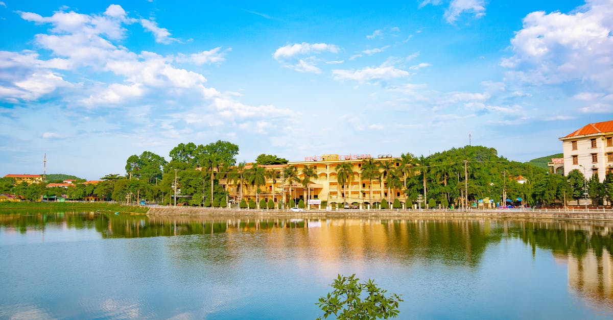Where to park e-scooters at hotels? - Hotel Building with Green Trees near River Where to park e-scooters at hotels? - Hotel Building with Green Trees near River