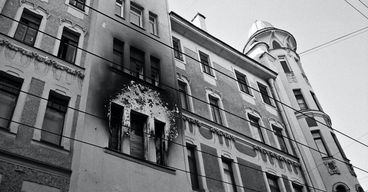 Where to print out flight info on a public holiday in Mexico City when your accommodation won't do it? - Black and white of exterior of aged residential building with dirty windows and walls after fire placed in city in daytime Where to print out flight info on a public holiday in Mexico City when your accommodation won't do it? - Black and white of exterior of aged residential building with dirty windows and walls after fire placed in city in daytime