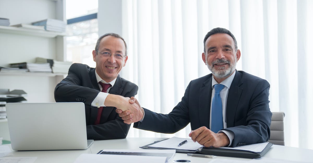 Where to rent a portable hotspot in Doha, Qatar? - Man in Black Suit Jacket Sitting Beside Man in Black Suit Where to rent a portable hotspot in Doha, Qatar? - Man in Black Suit Jacket Sitting Beside Man in Black Suit
