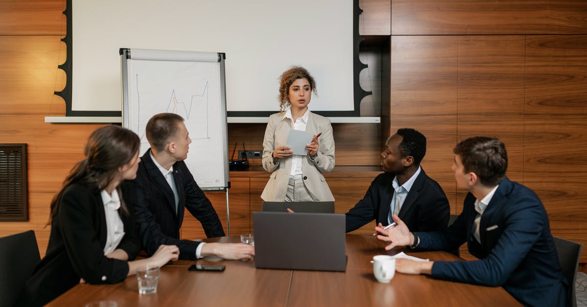 Where to rent a portable hotspot in Doha, Qatar? - Woman in White Dress Shirt Sitting Beside Man in Black Suit Where to rent a portable hotspot in Doha, Qatar? - Woman in White Dress Shirt Sitting Beside Man in Black Suit