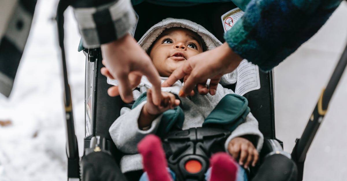 Where to repair baby stroller in Nîmes or elsewhere in France? - Crop parents with black baby in carriage Where to repair baby stroller in Nîmes or elsewhere in France? - Crop parents with black baby in carriage