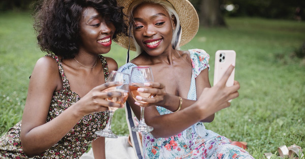 Where was this picture taken? - Woman in White Red and Green Floral Dress Holding White Smartphone Where was this picture taken? - Woman in White Red and Green Floral Dress Holding White Smartphone