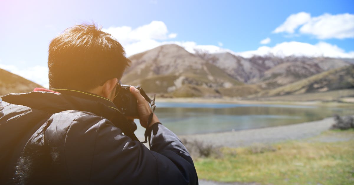 Where was this picture taken? (Chromecast background, 3 steep rocks) - Man Taking Photo of Mountain
