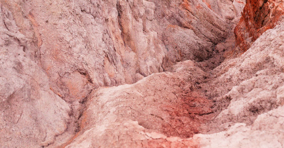 Where was this picture taken? (Chromecast background, 3 steep rocks) - Rough surface of rocky formation in sunlight