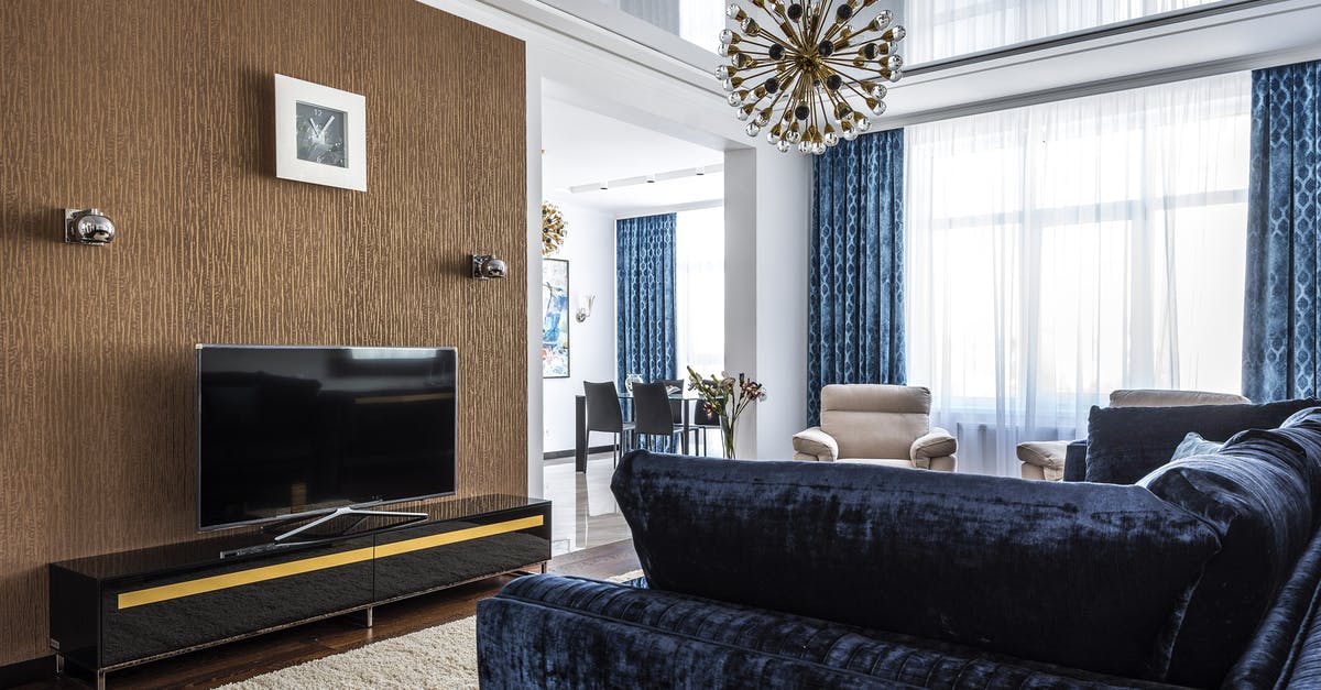 Where was this picture taken (screensaver on LG Oled TV)? - Interior design of spacious living room with comfortable couch with armchairs and TV set in modern apartment Where was this picture taken (screensaver on LG Oled TV)? - Interior design of spacious living room with comfortable couch with armchairs and TV set in modern apartment