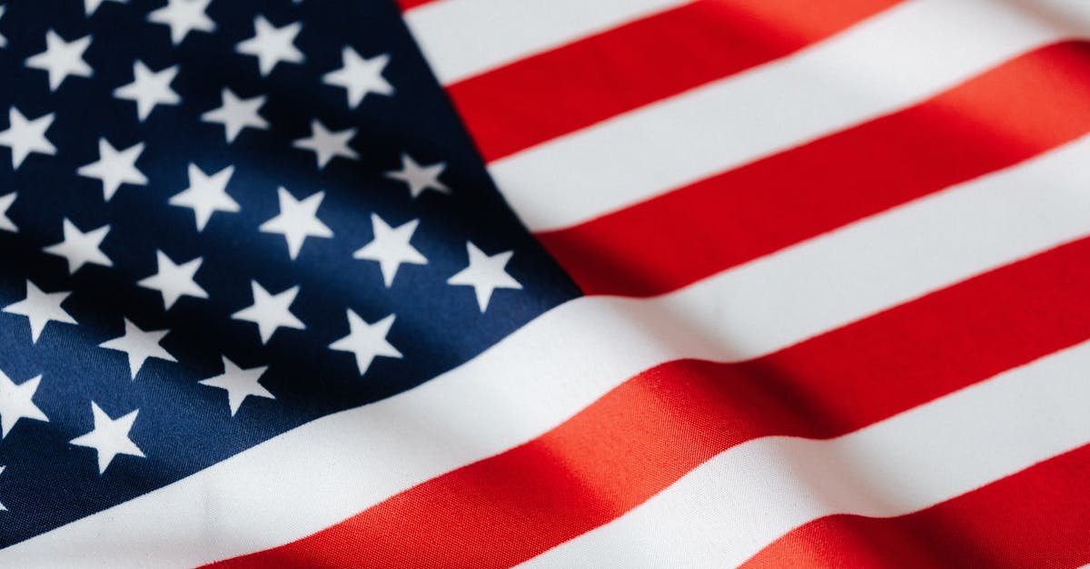 Which airlines are the US flag carrier? - From above of closeup flattering national flag of USA with white and red stripes and stars on blue background Which airlines are the US flag carrier? - From above of closeup flattering national flag of USA with white and red stripes and stars on blue background