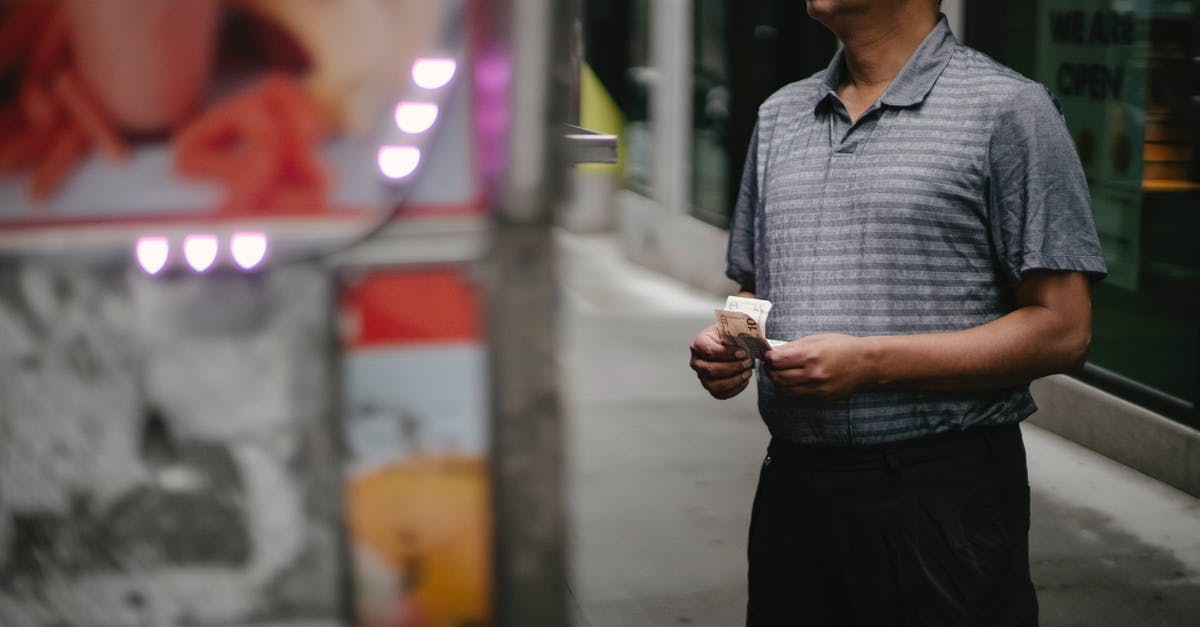 Which ATMs offer no-fee cash withdrawals in Chile? - Crop male customer with banknotes in eyeglasses making choice at food truck on street Which ATMs offer no-fee cash withdrawals in Chile? - Crop male customer with banknotes in eyeglasses making choice at food truck on street